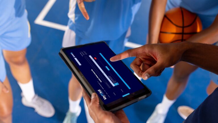 PE teacher and students using MyPEkit on a tablet